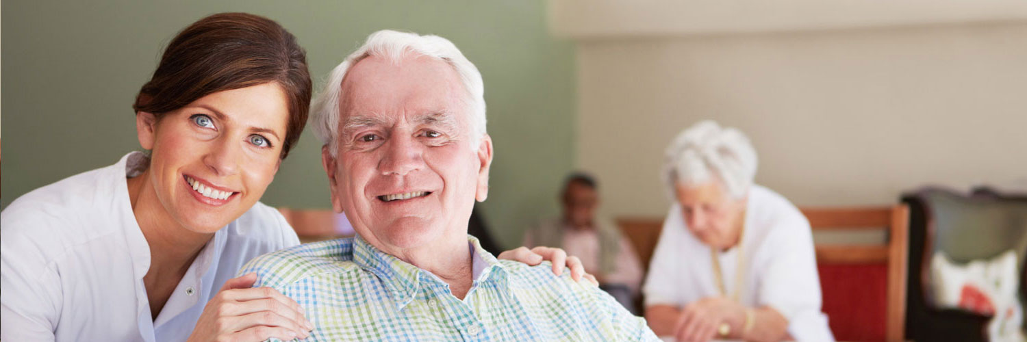 caregiver with hands on elderly man's shoulders